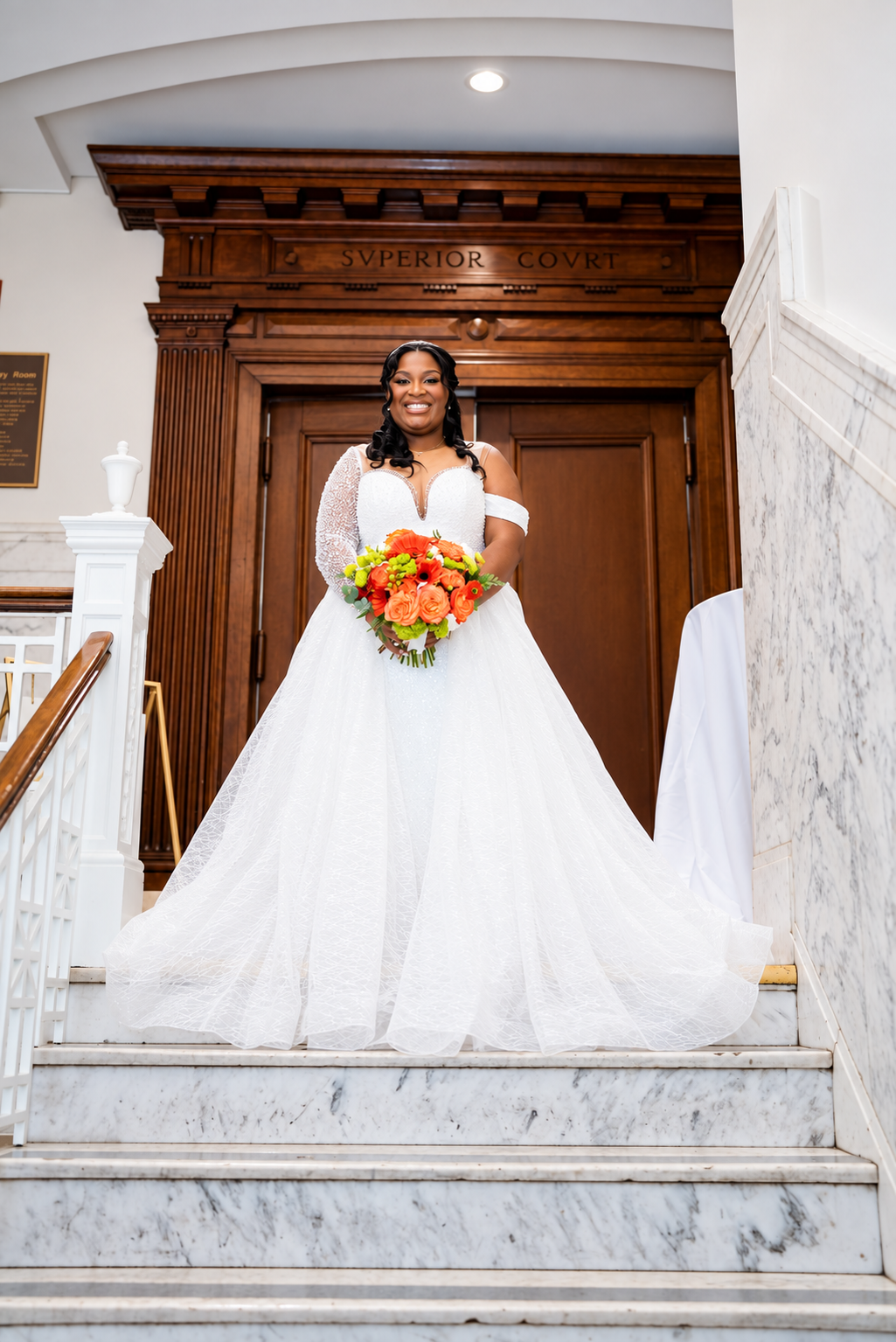 Aaliyah in a bridal portrait on the staircase