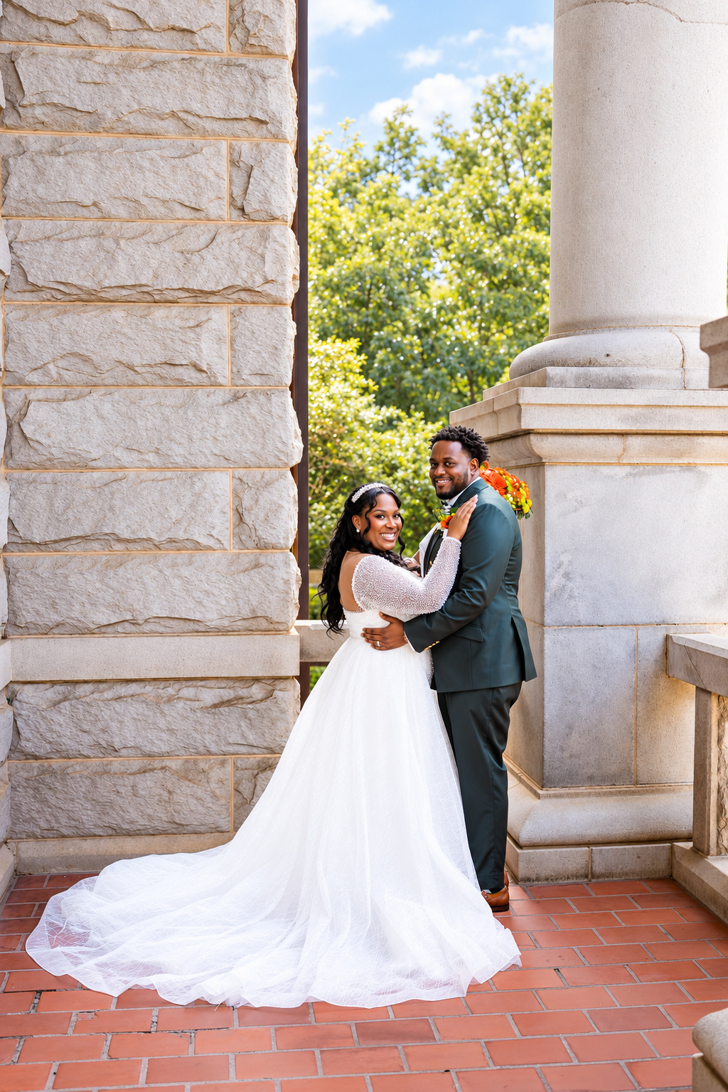 Aaliyah and Alex together beside architectural columns