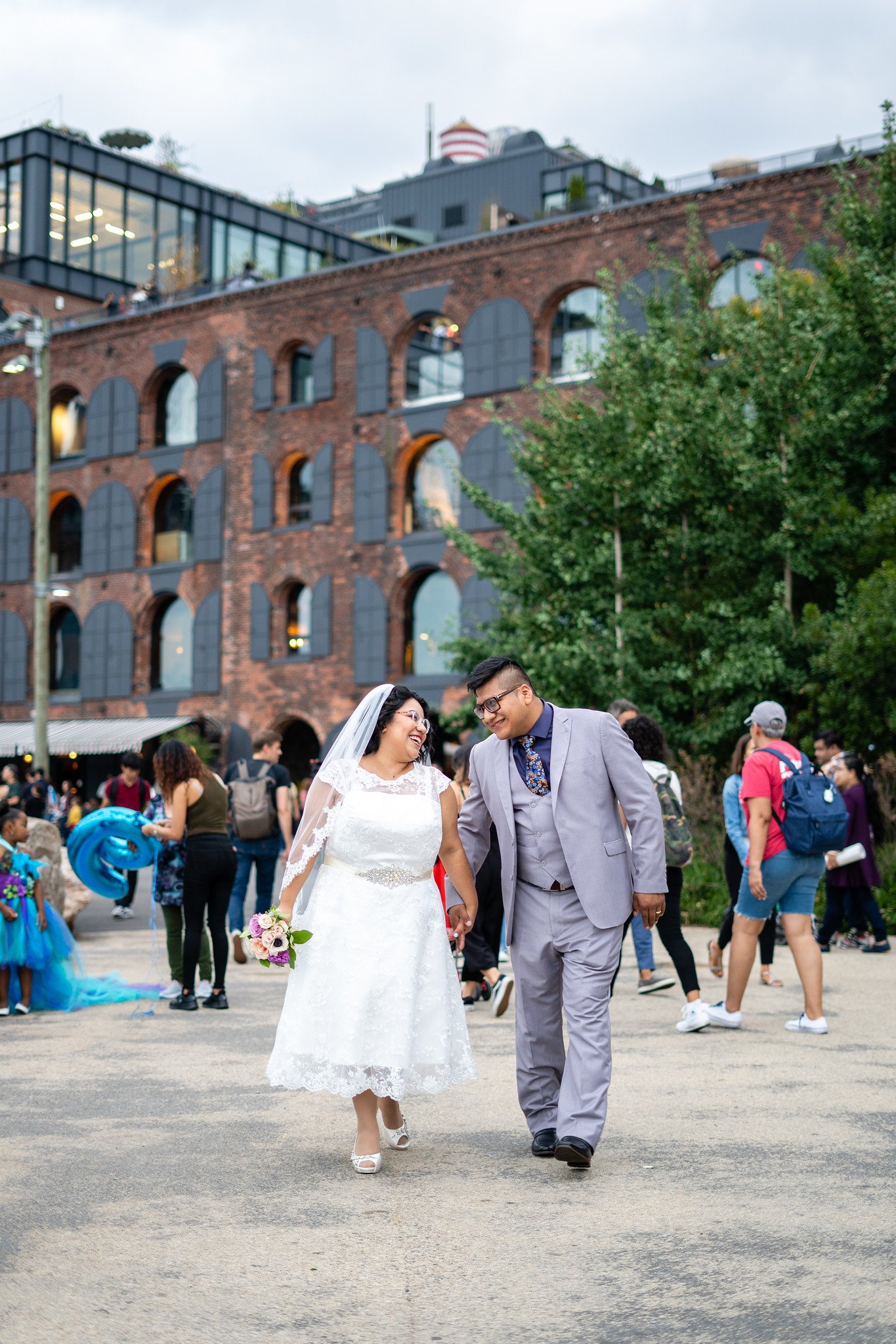 Brenda and David walk through a lively city street.
