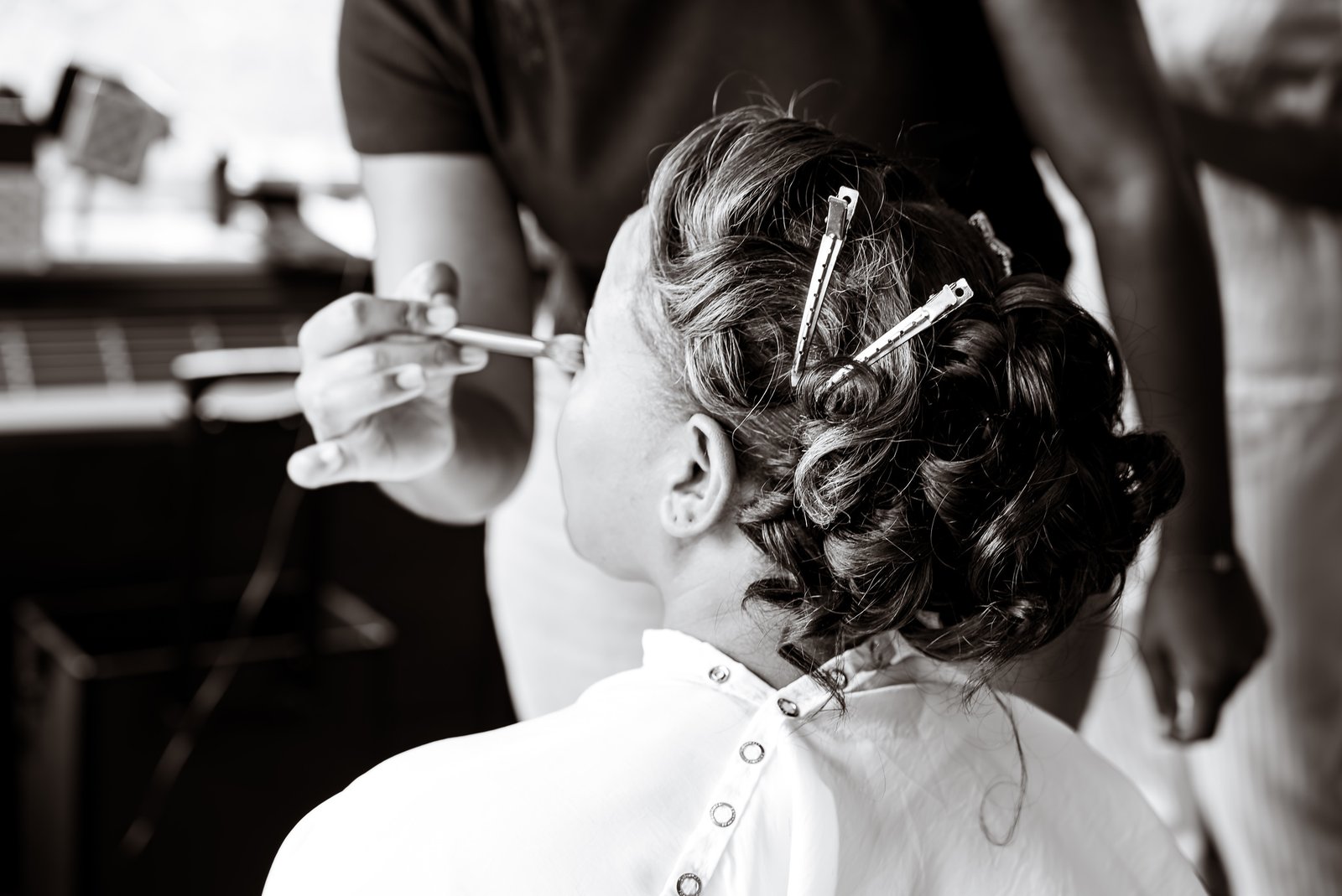 Makeup being finished before the wedding ceremony.