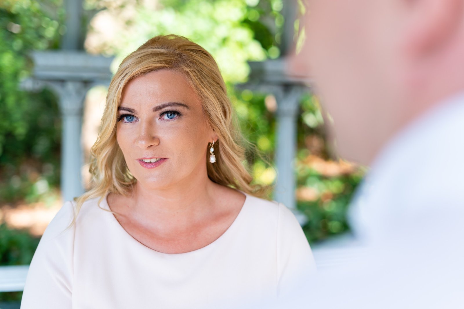 A close portrait of Mary looking toward Shamus during the ceremony.