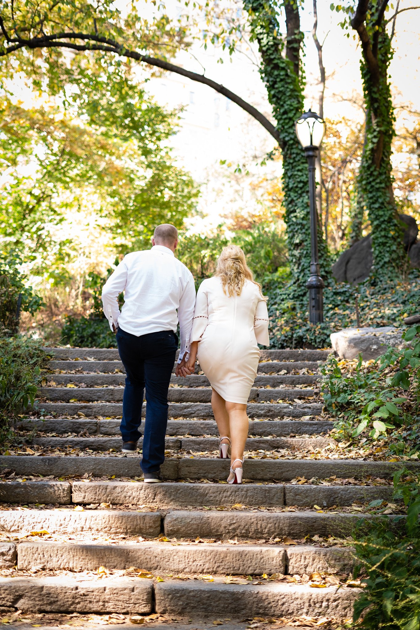 The newlyweds walk away together up a flight of stone steps.
