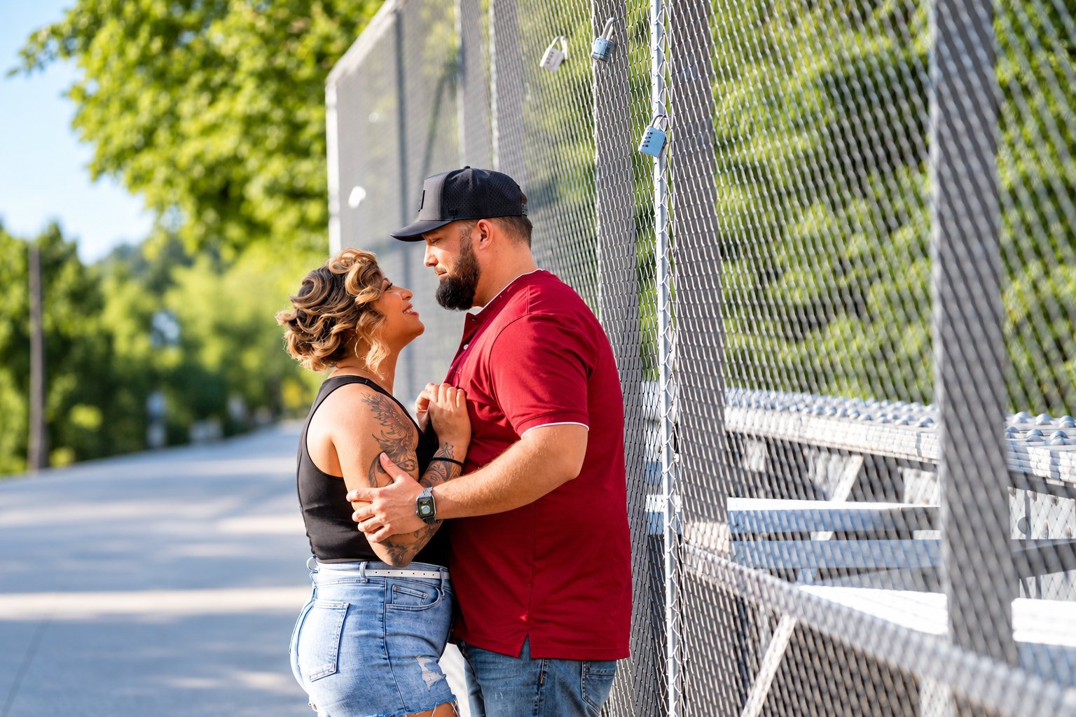 Ashley and Hunter facing each other beside a pedestrian bridge in Atlanta
