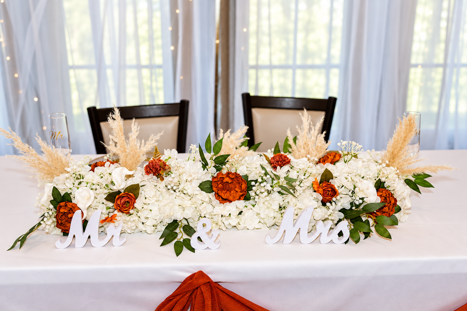 Orange ivory sweetheart table at Burnett and Jaelyn's wedding