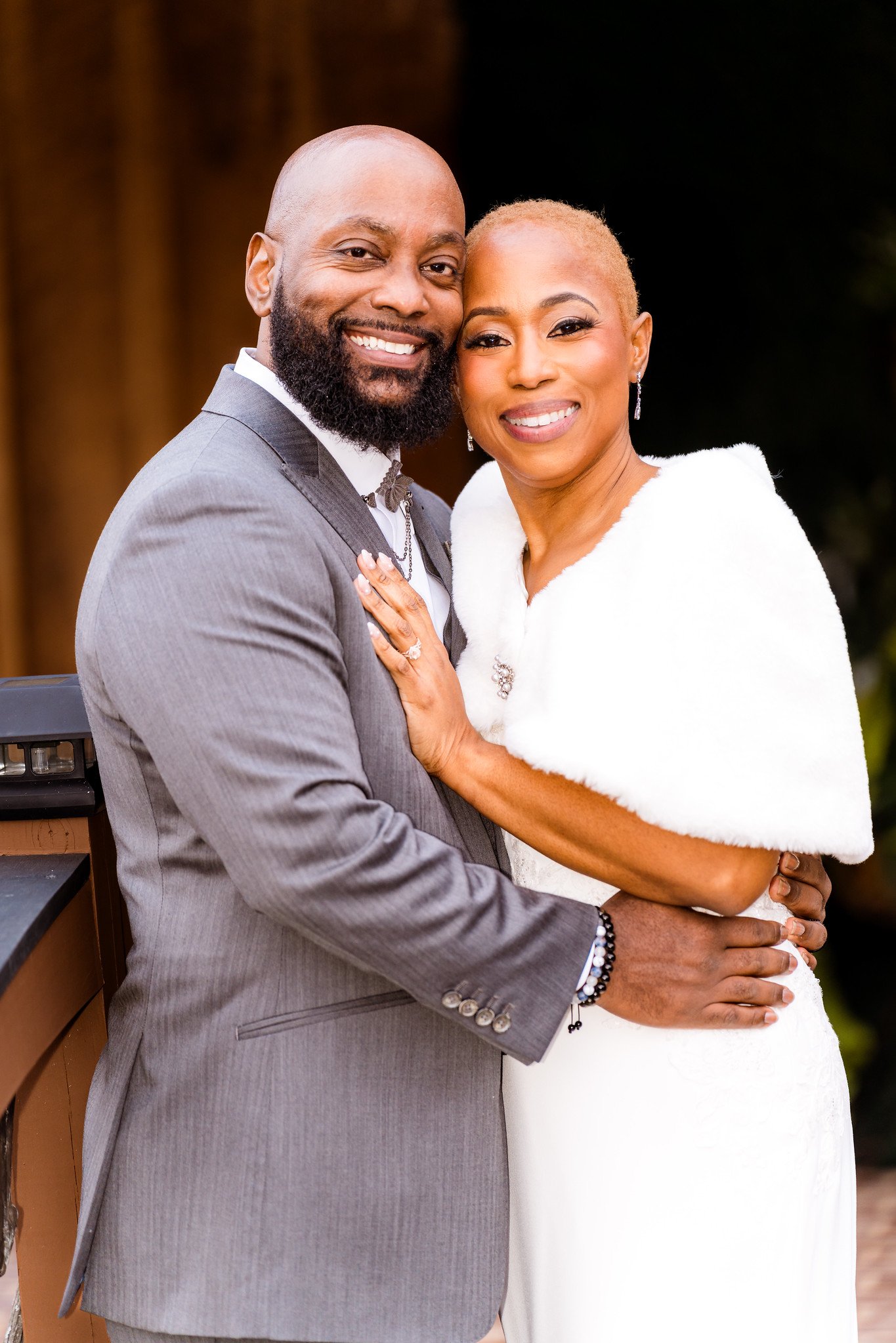 Maurice and Jillian embrace and smile in the doorway