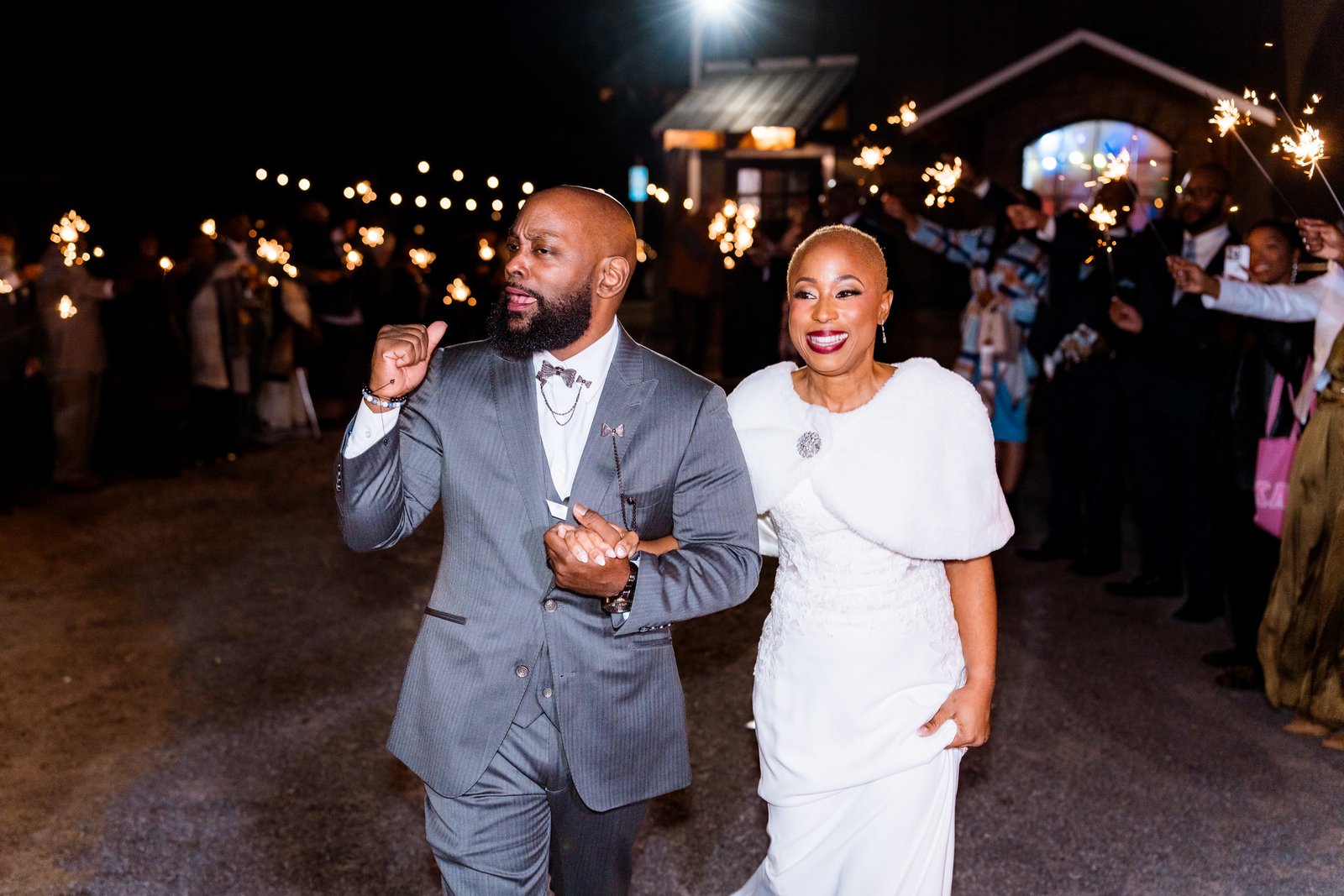 Maurice and Jillian leave hand in hand beneath their guests' sparklers