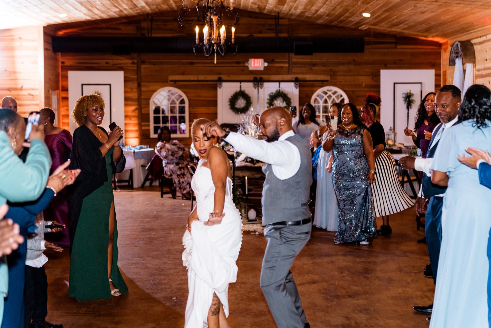 Maurice twirls Jillian as guests cheer around the dance floor