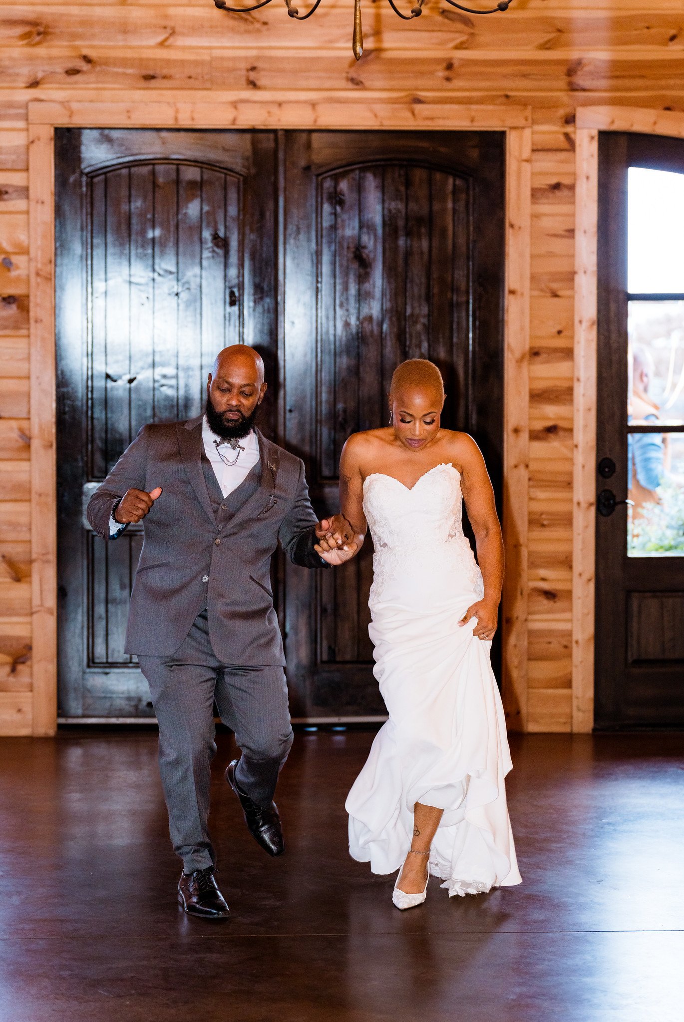 Maurice and Jillian enter their reception hand in hand