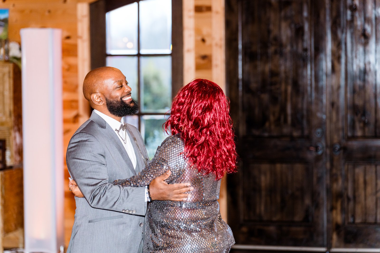 Maurice smiles during a reception dance with a family member