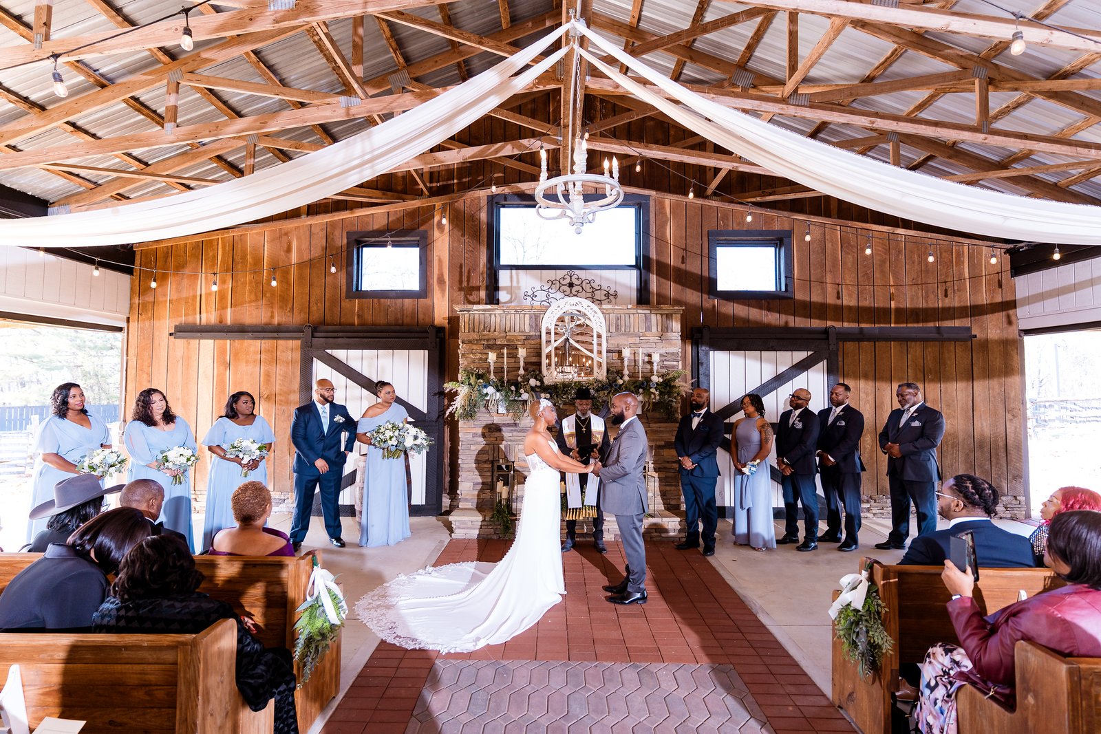 Maurice and Jillian exchange vows beneath the chapel's timber beams