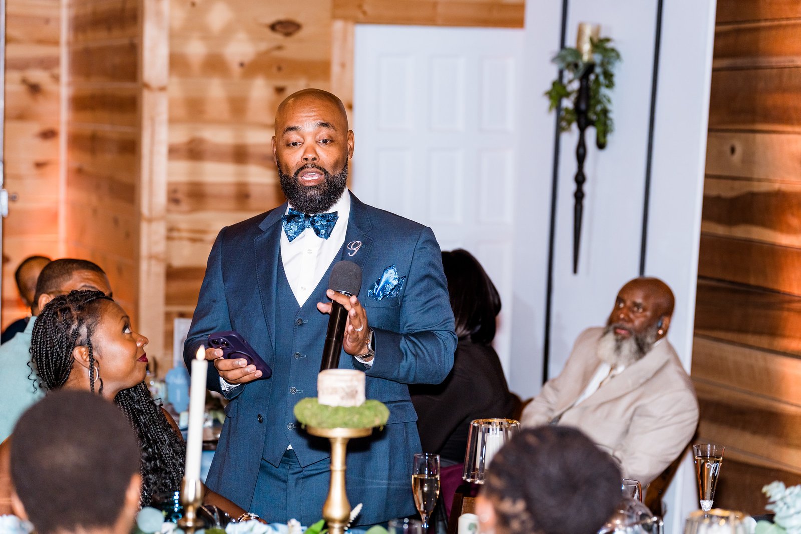 A wedding guest gives a speech at the reception