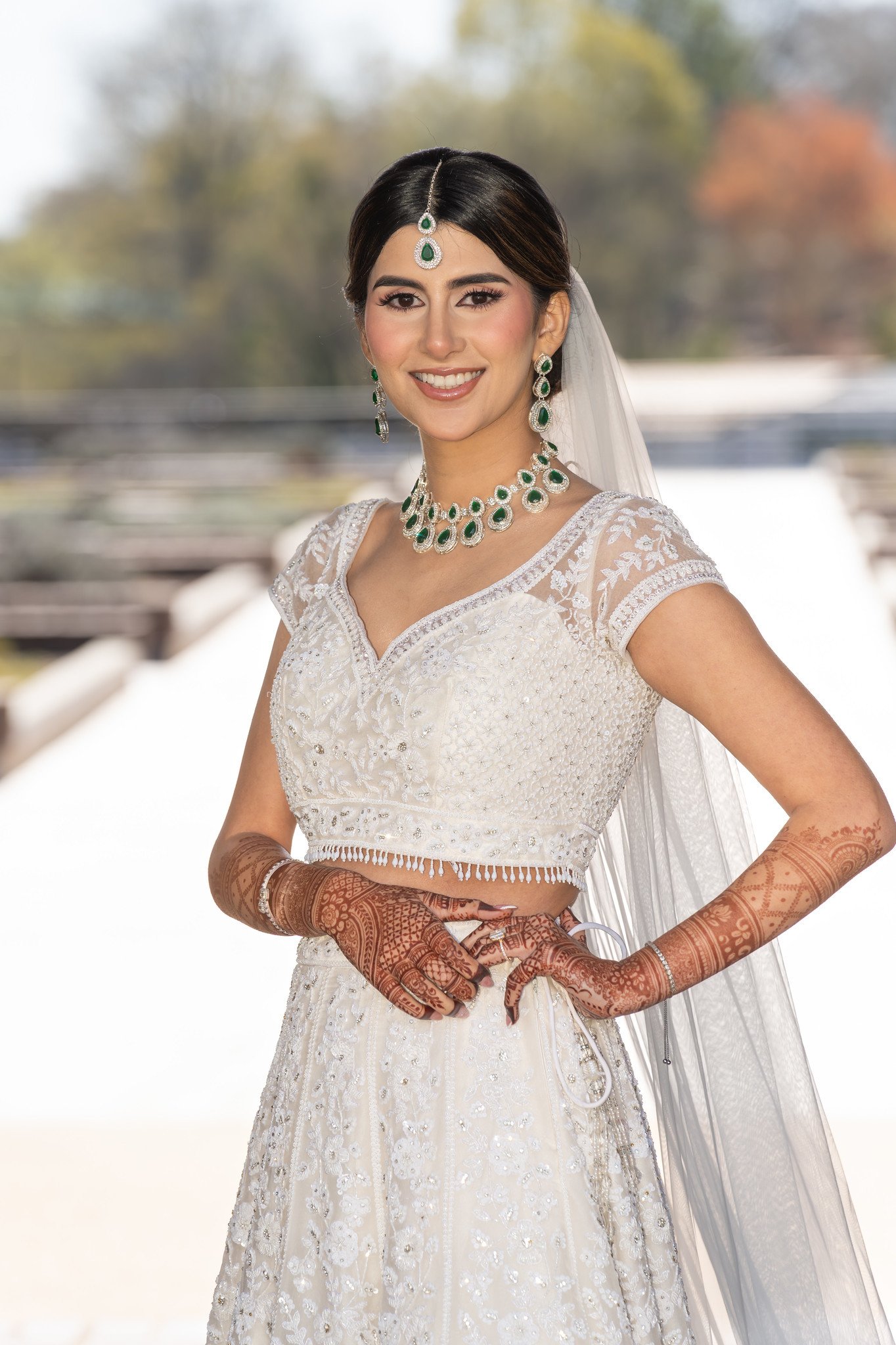 Mehreen in an embroidered ivory gown and green jewelry