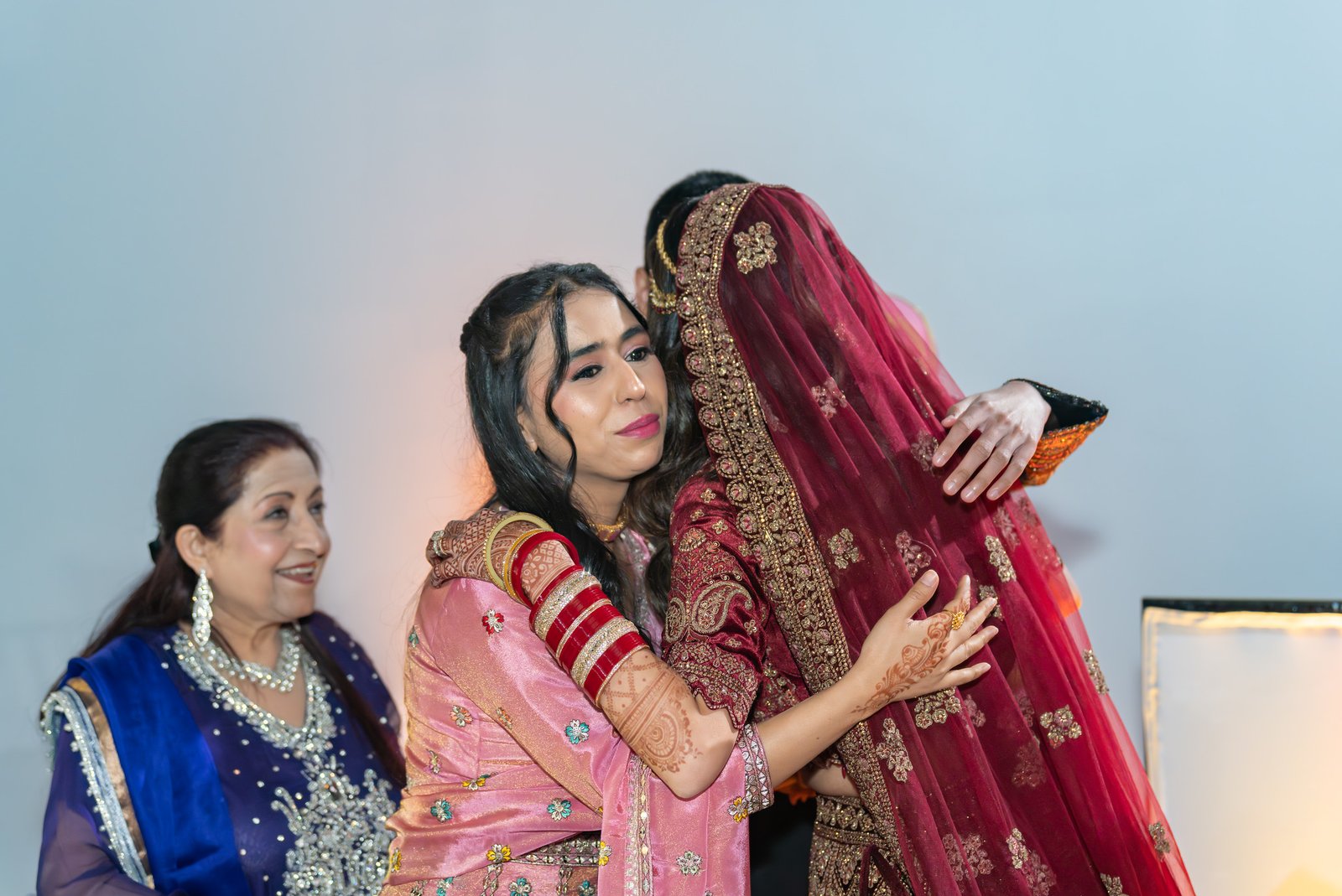 Mehreen embraces a guest at the reception