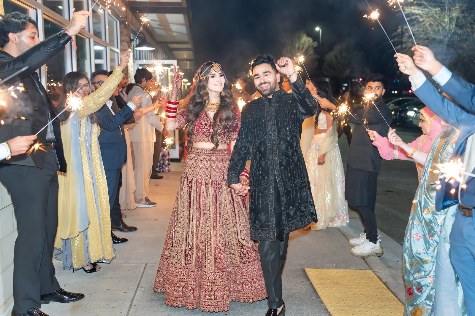Mehreen and Shahzain walk hand in hand through a sparkler send-off
