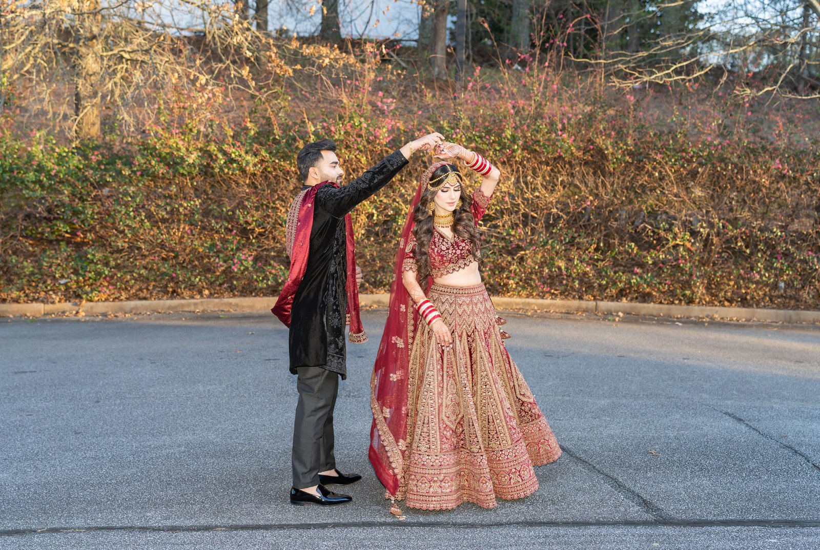 Shahzain twirls Mehreen in her red embroidered gown outdoors