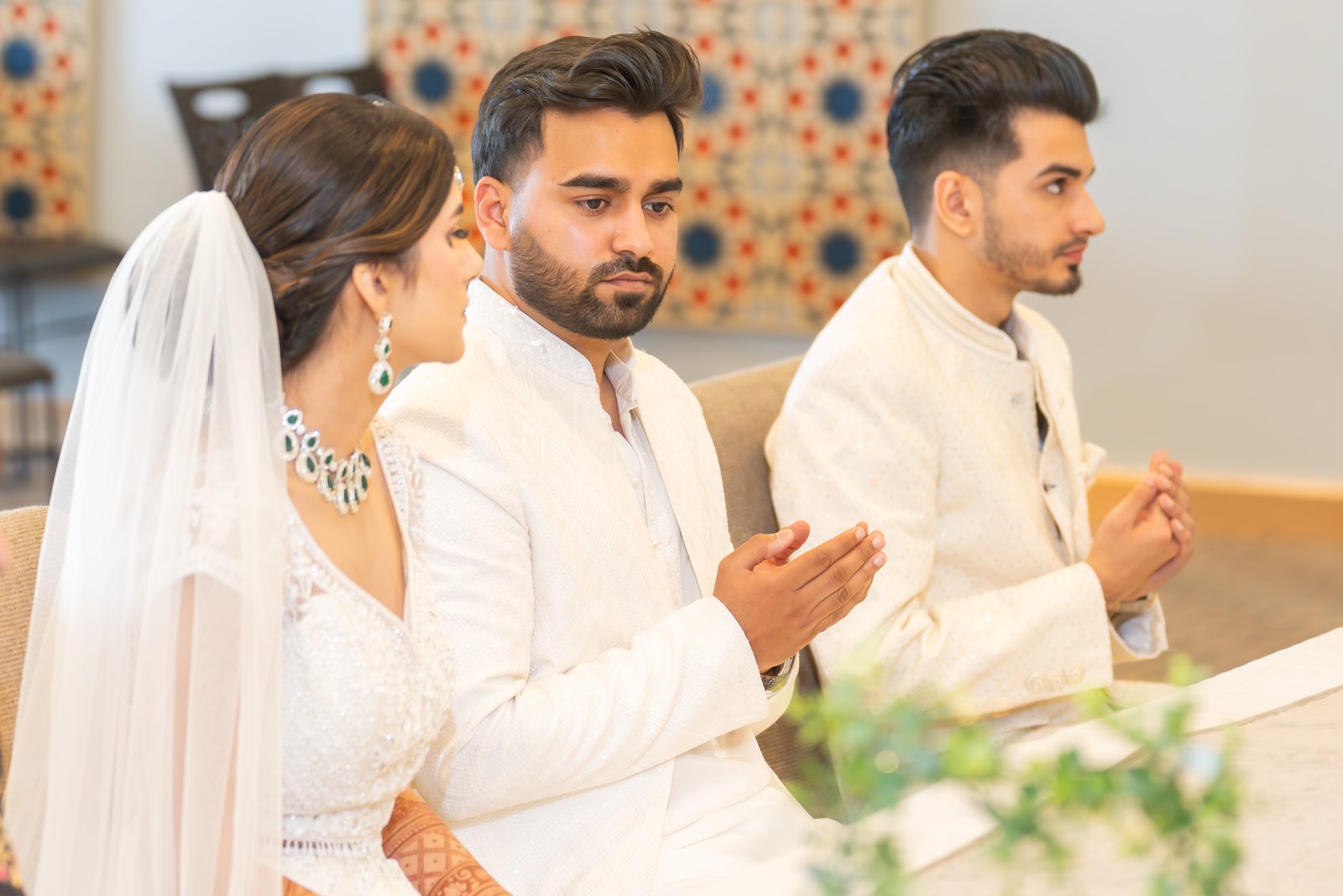 Shahzain raises his hands in prayer beside Mehreen