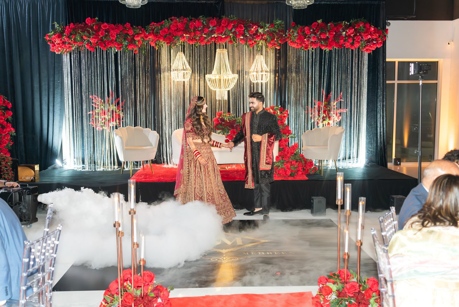 Mehreen and Shahzain begin dancing beneath chandeliers and red flowers