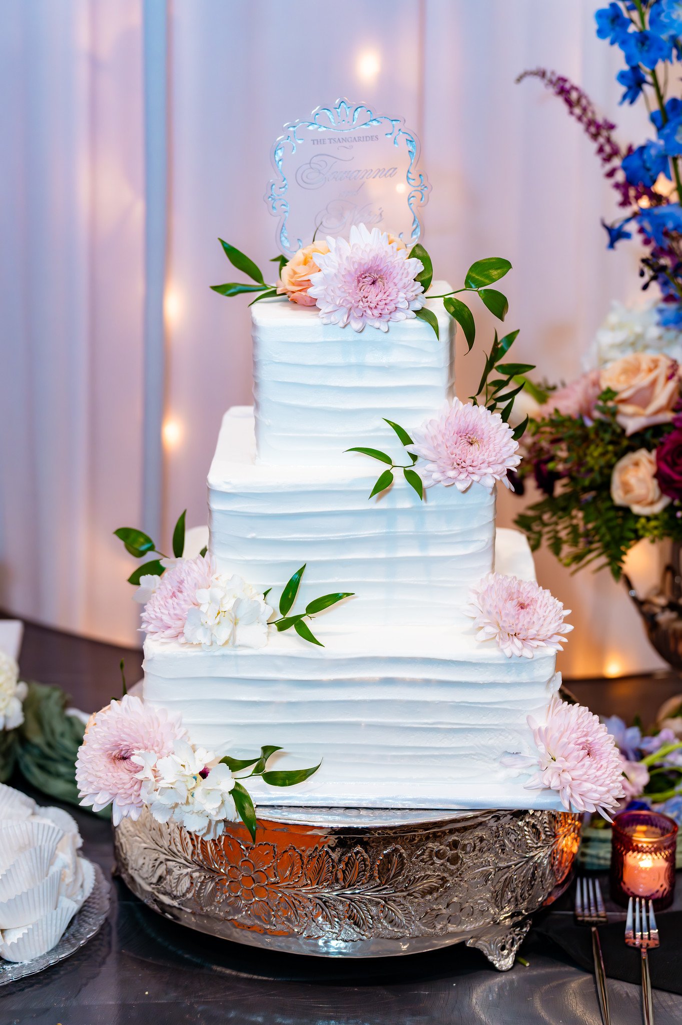 White wedding cake decorated with pink flowers