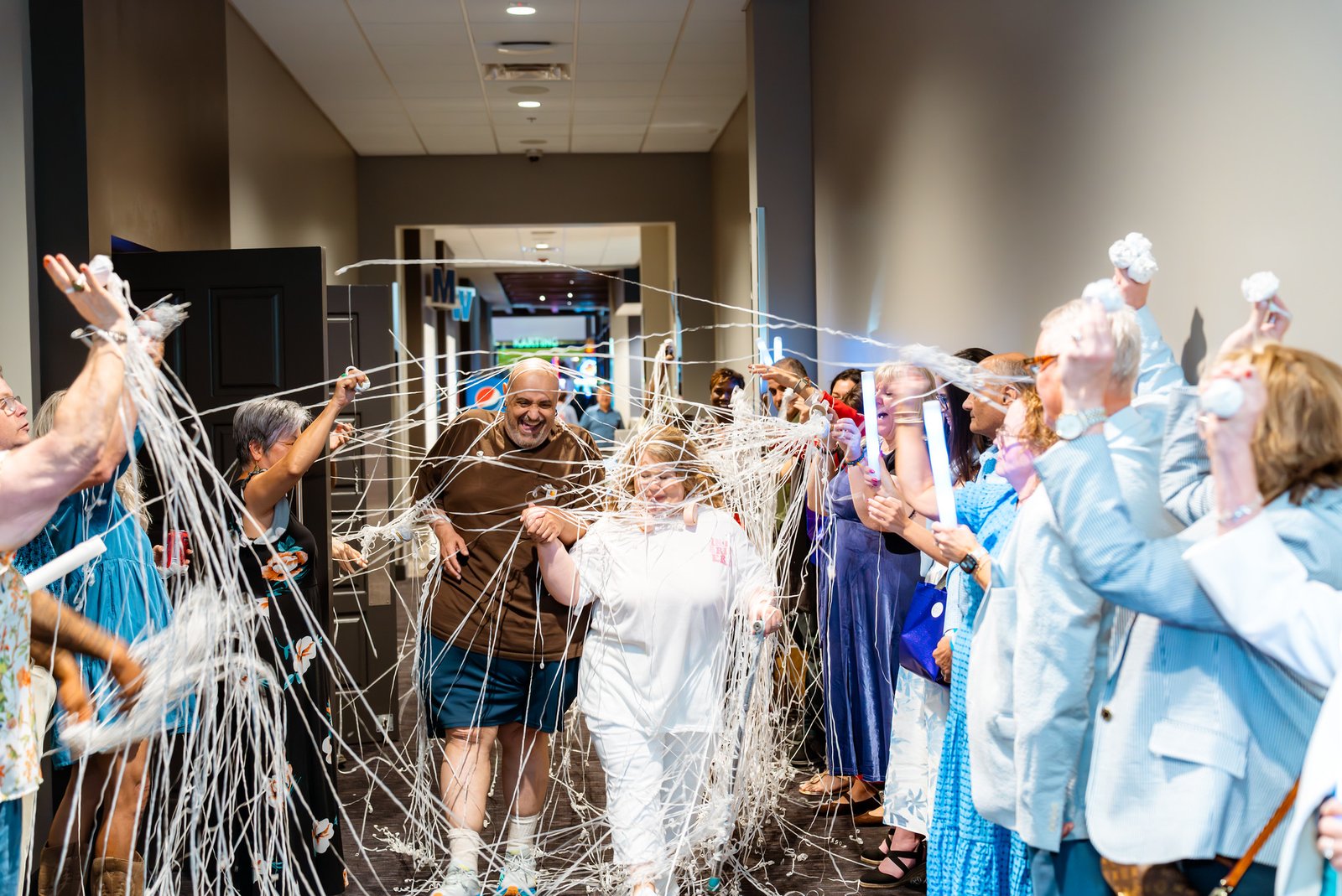 Noris and Towanna leave through a shower of streamers
