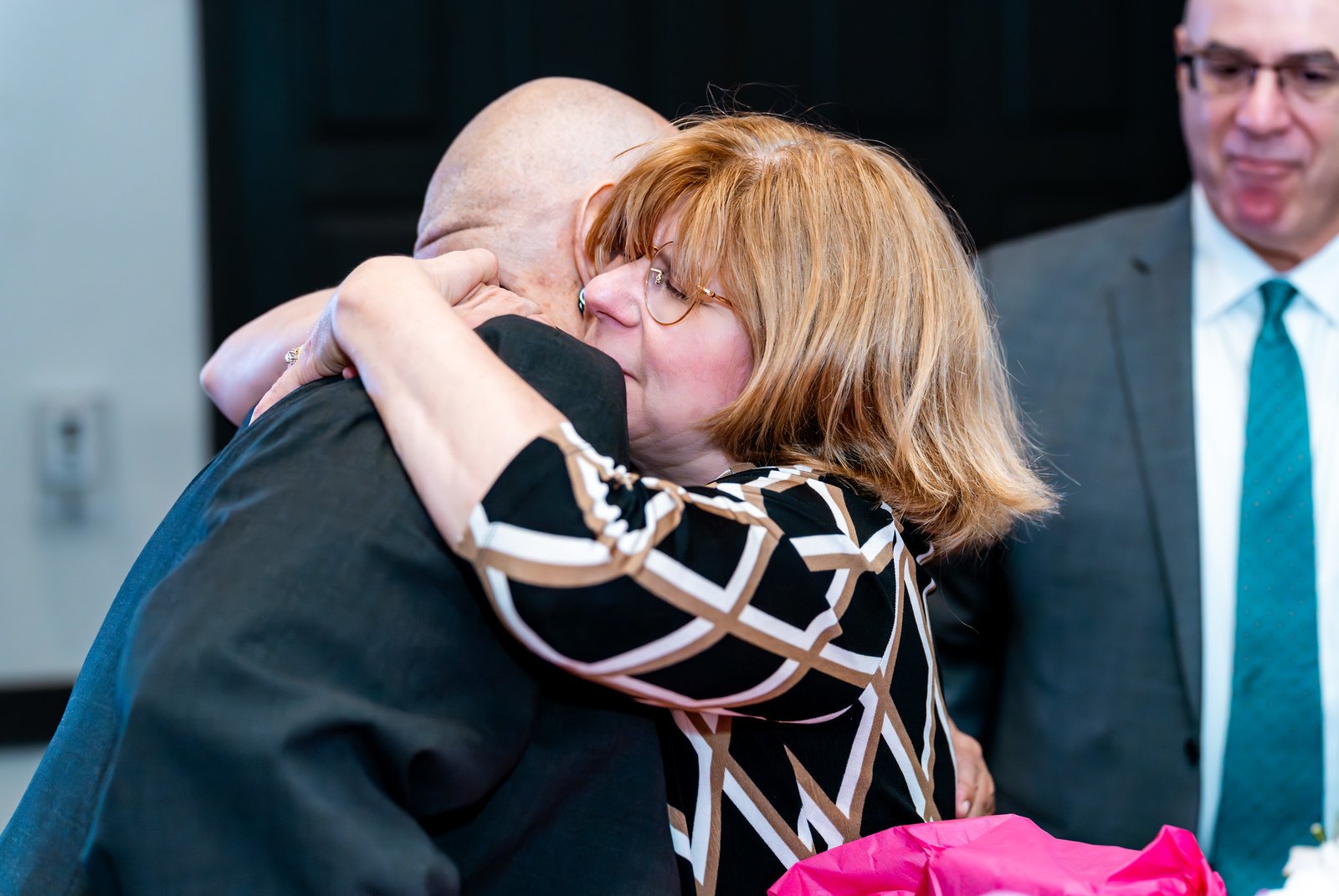 Noris shares an embrace with a smiling guest