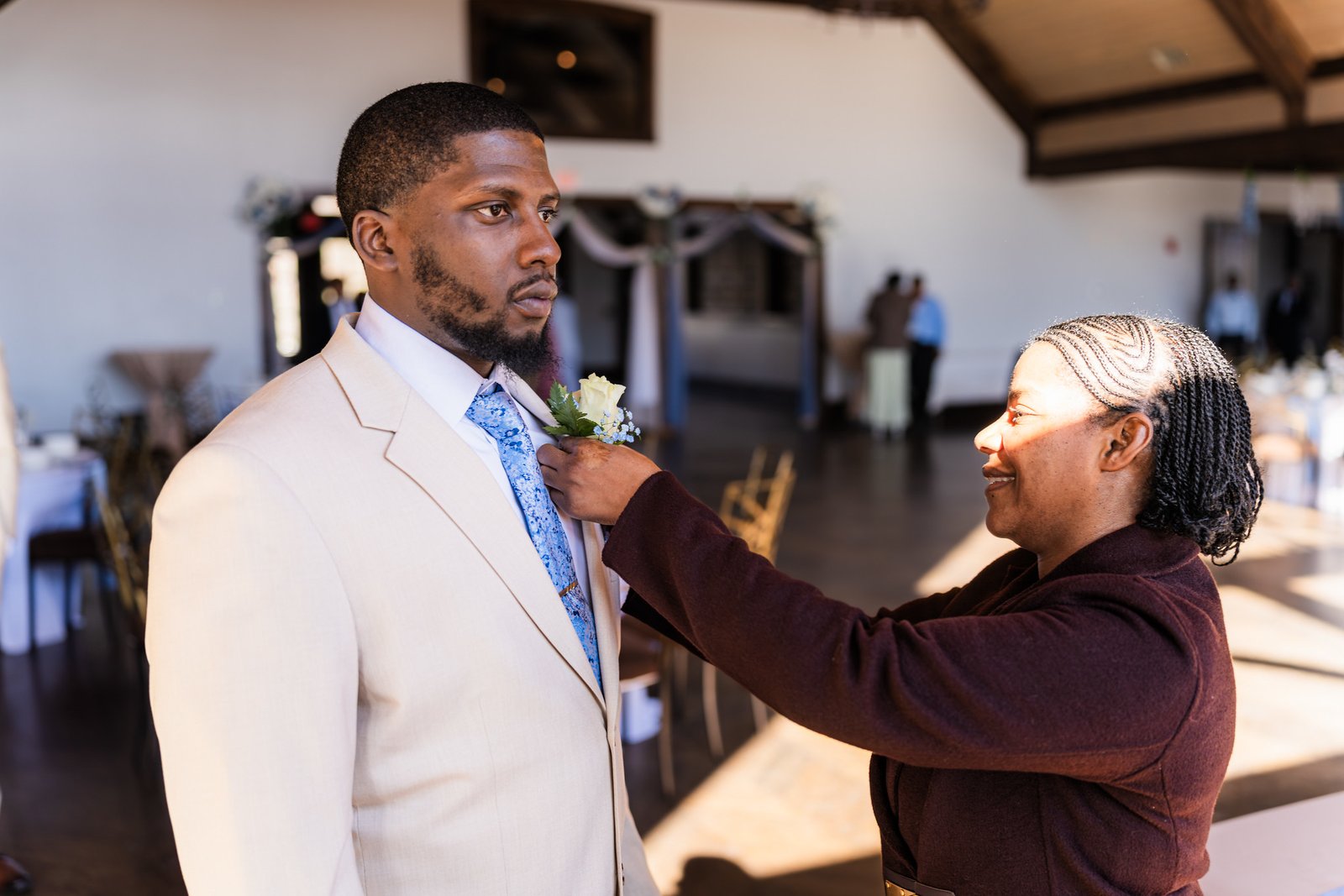 A family member pins Marcel's boutonniere