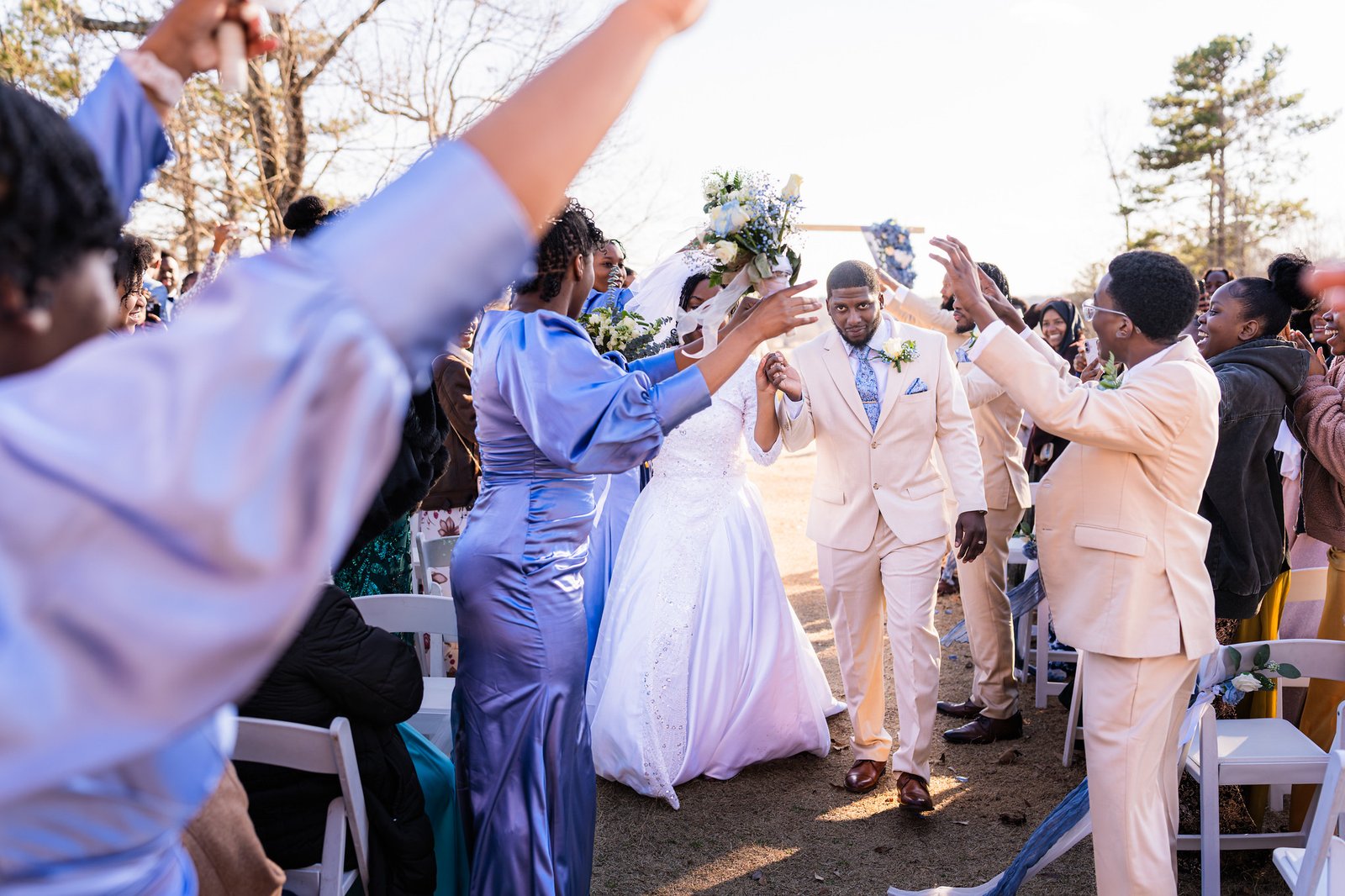 The wedding party raises a joyful arch for Tanjana and Marcel