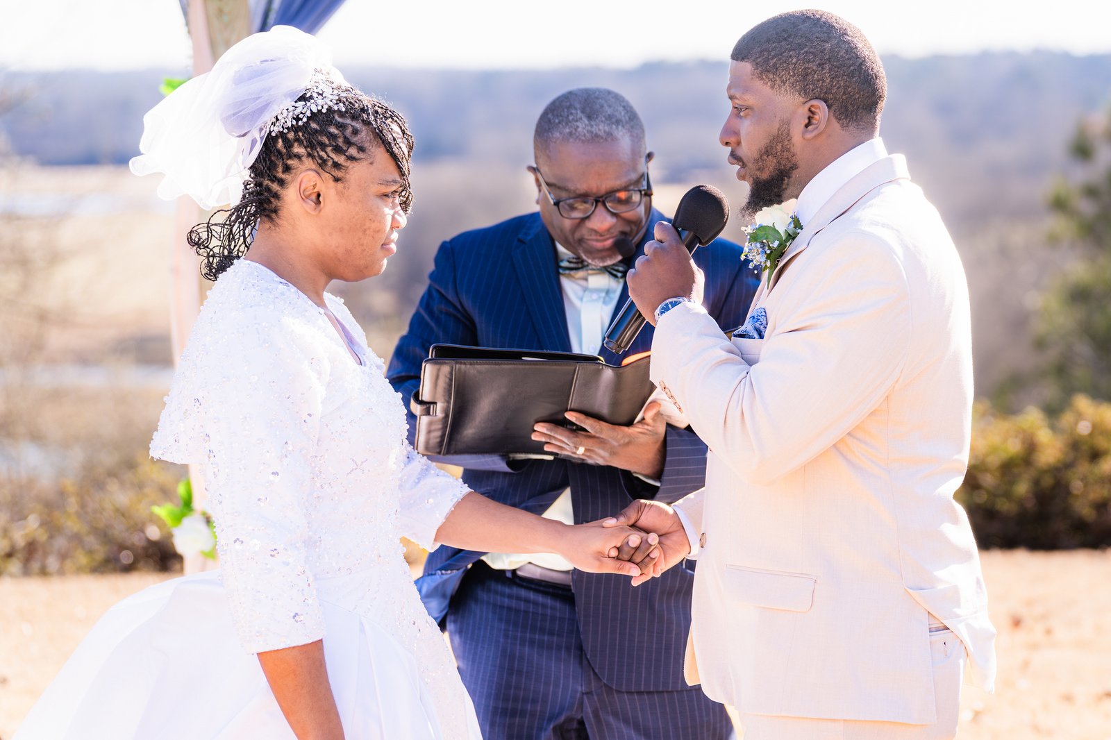 Marcel speaks his vows while holding Tanjana's hand