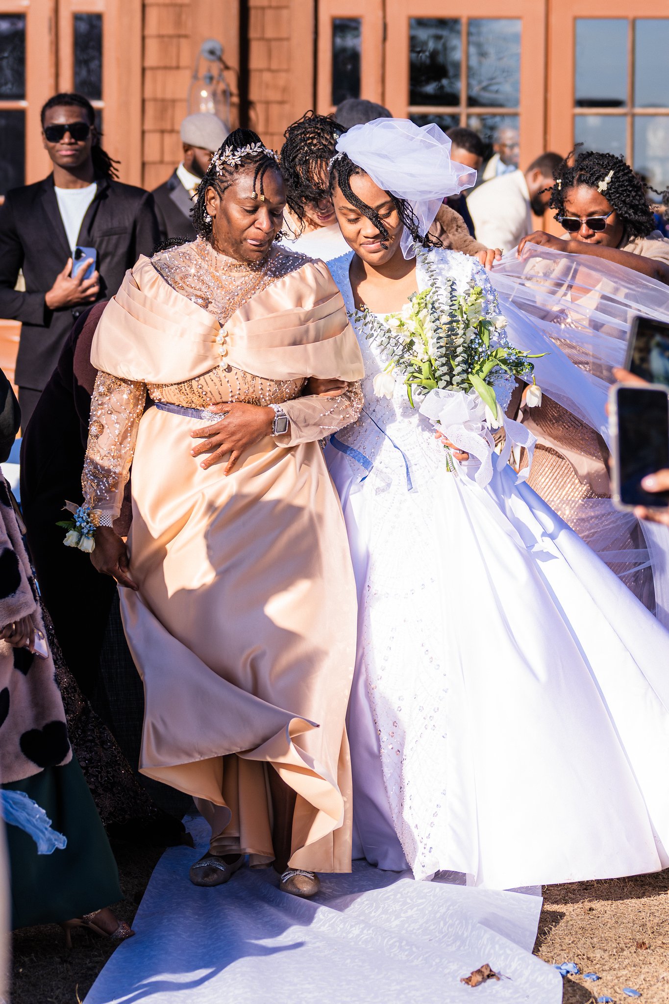 Tanjana walks toward the ceremony with a family member
