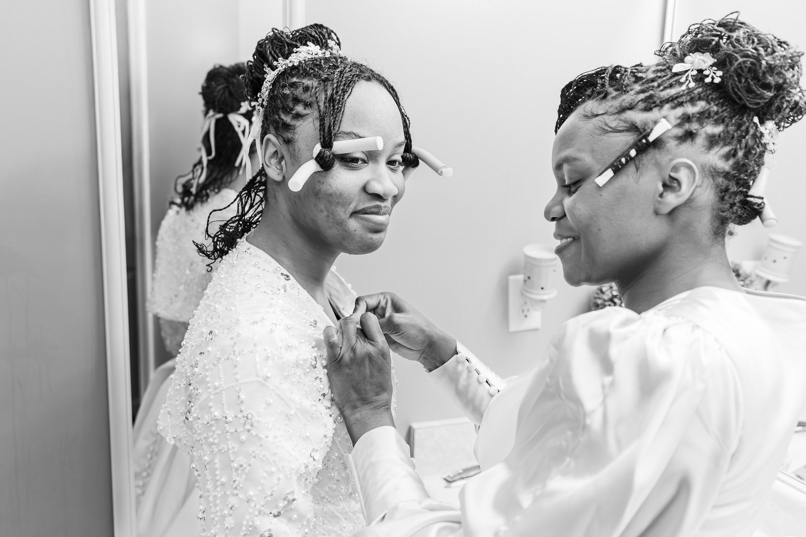 A quiet moment as Tanjana's wedding outfit is fastened