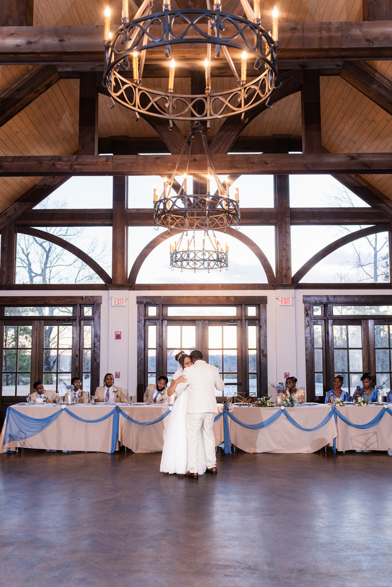 Tanjana and Marcel dance beneath the reception chandeliers