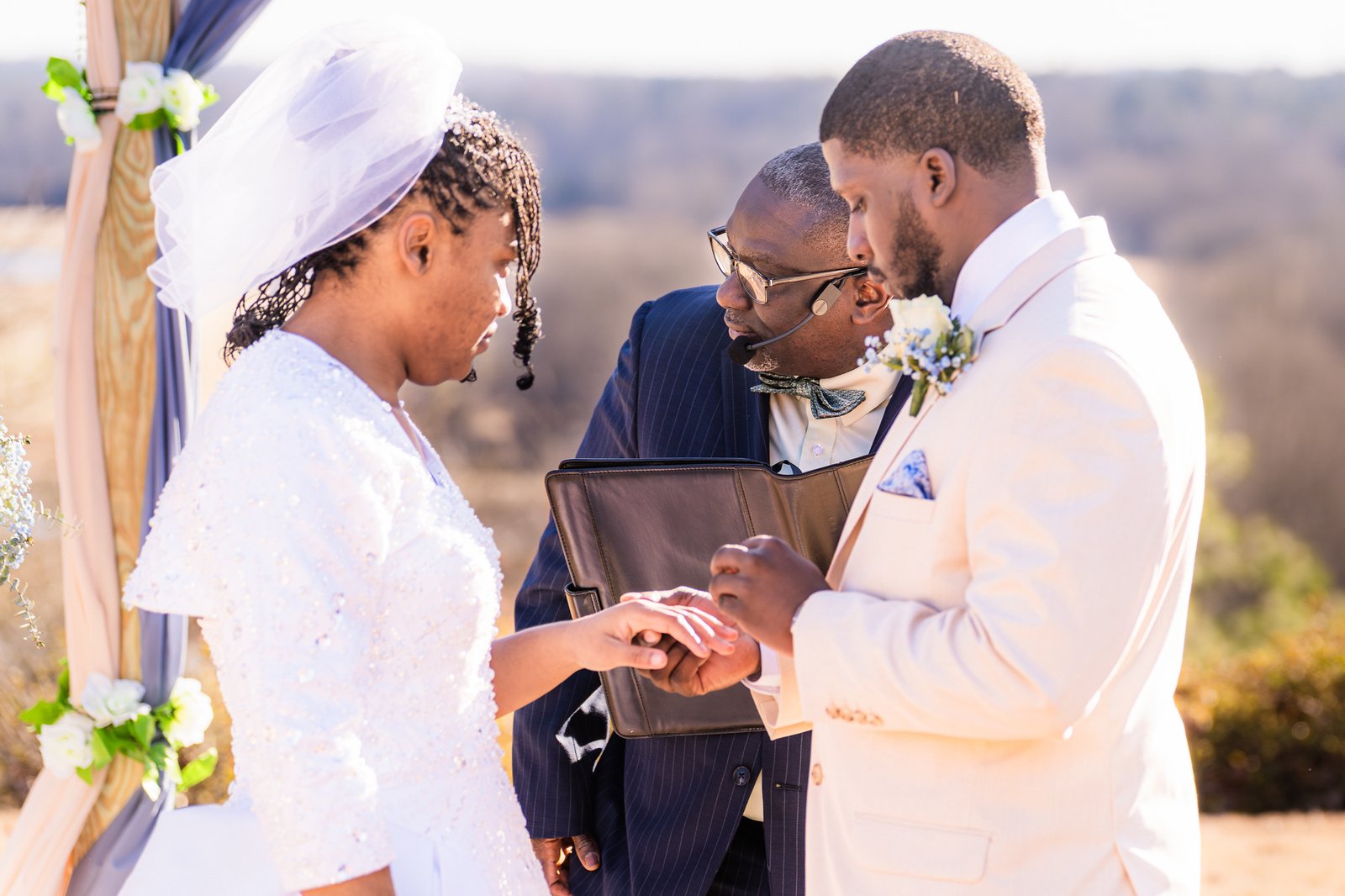 Marcel places a wedding ring on Tanjana's finger