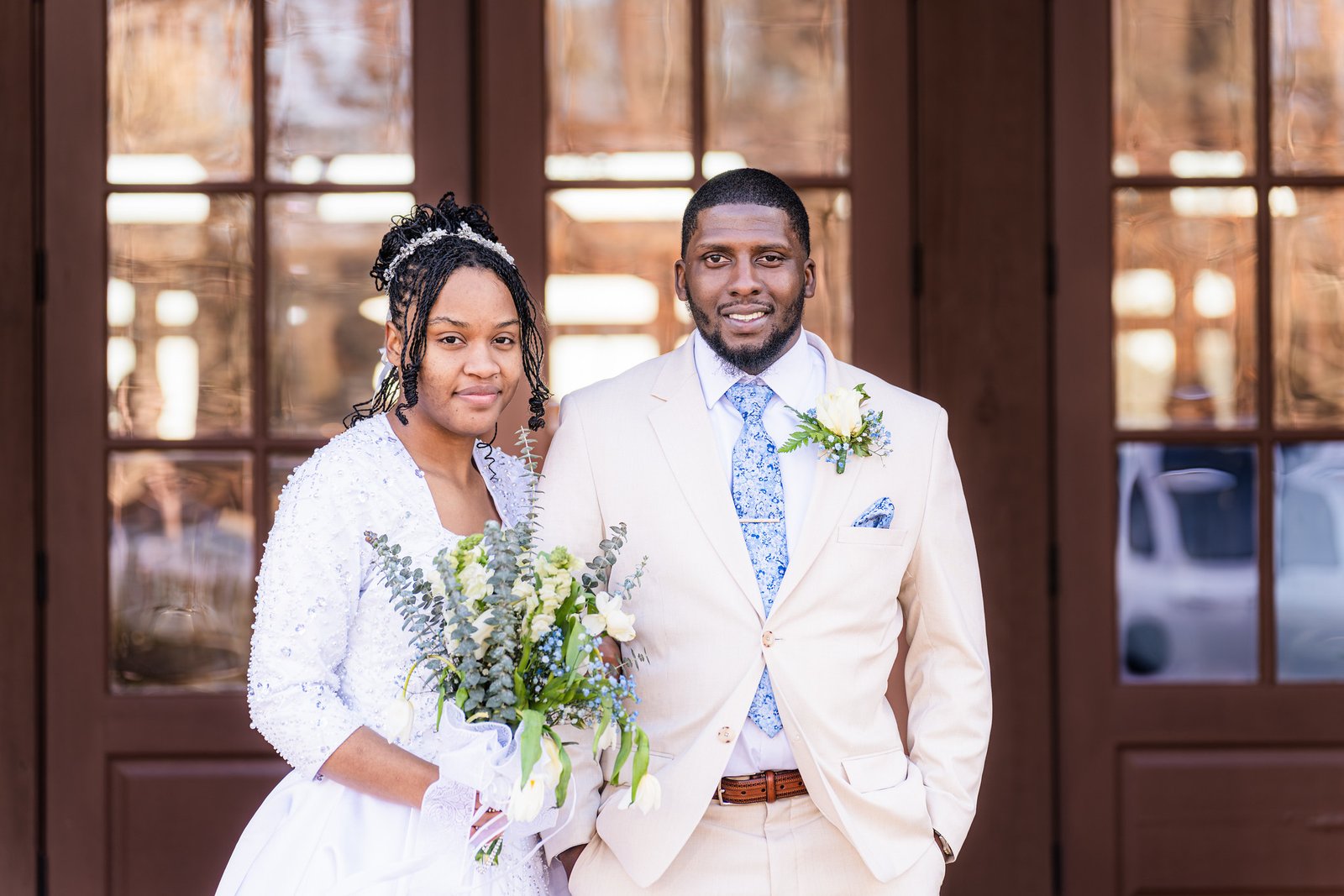 Tanjana and Marcel smile together in a wedding portrait
