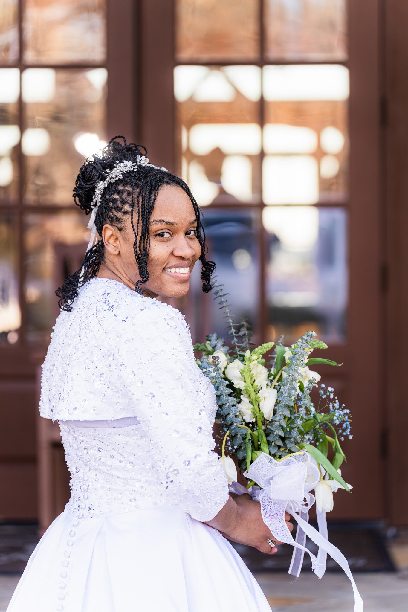 Tanjana looks back and smiles with her bouquet