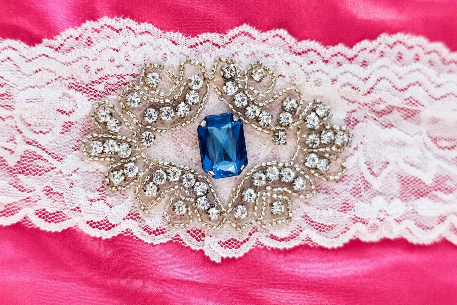 Pink wedding details with a jeweled garter