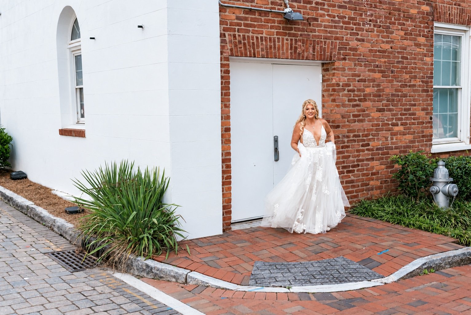 Mikayla’s bridal portrait beside a brick building in Marietta