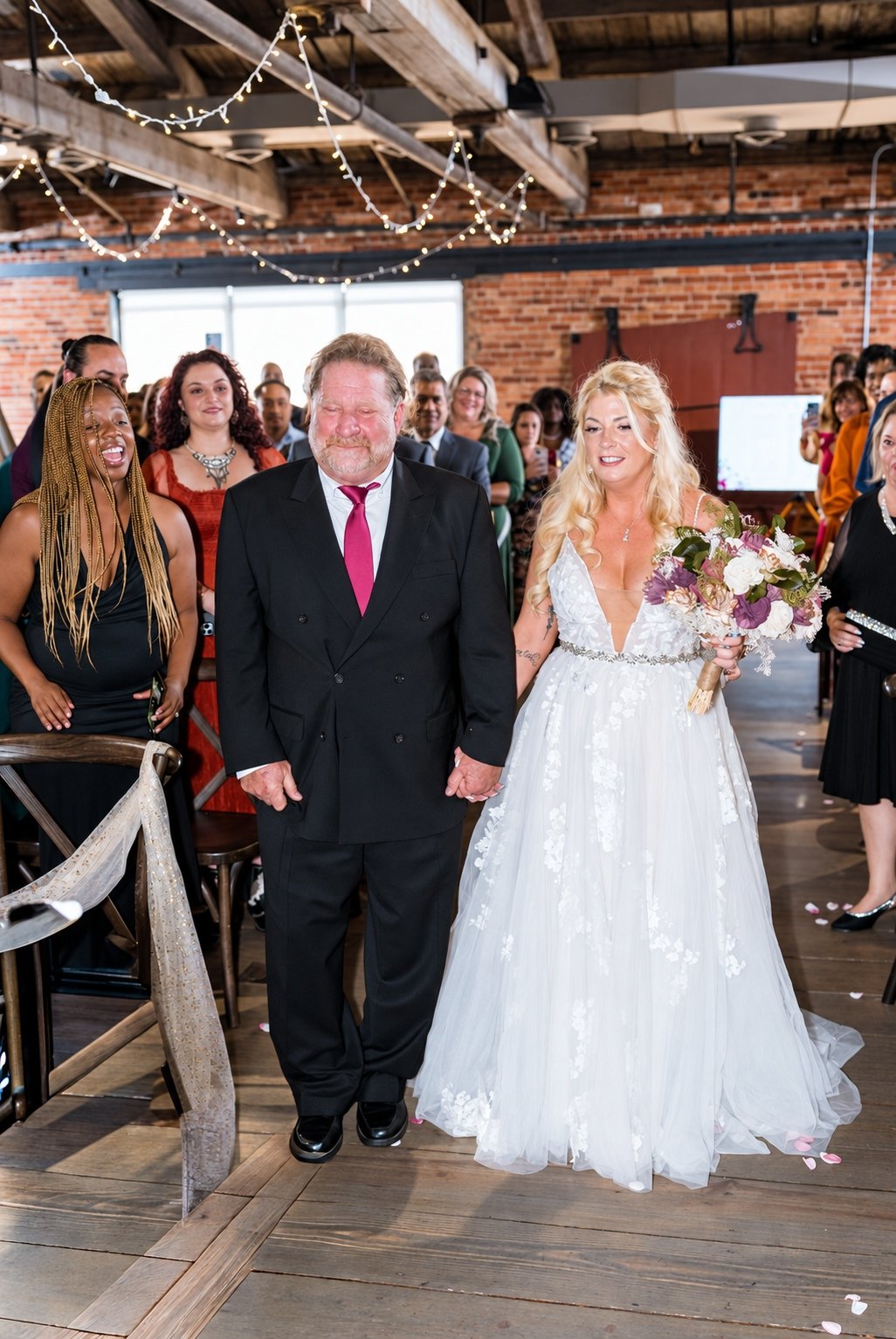 Mikayla walking down the aisle with a loved one