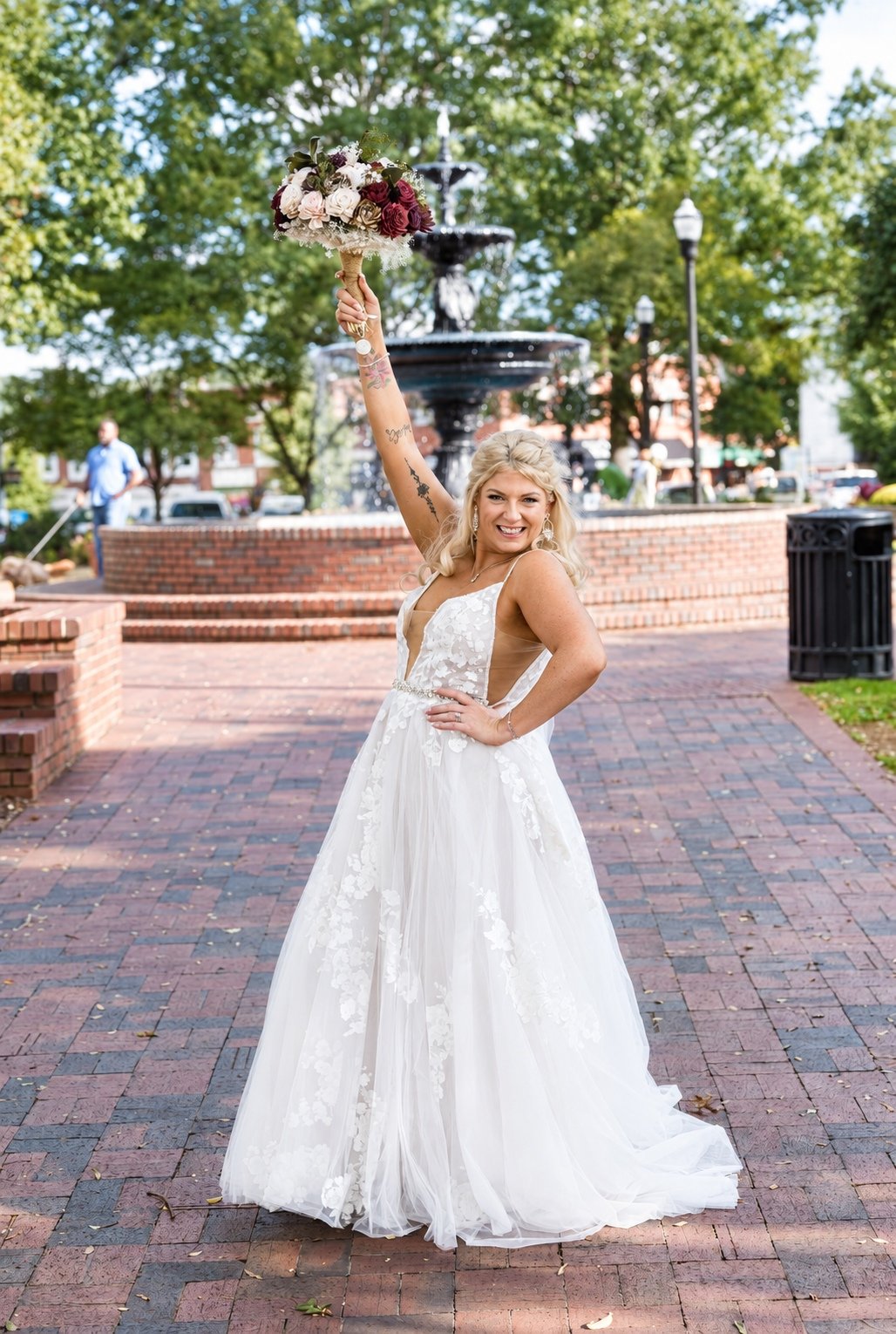 Mikayla raising her bouquet in Marietta Square