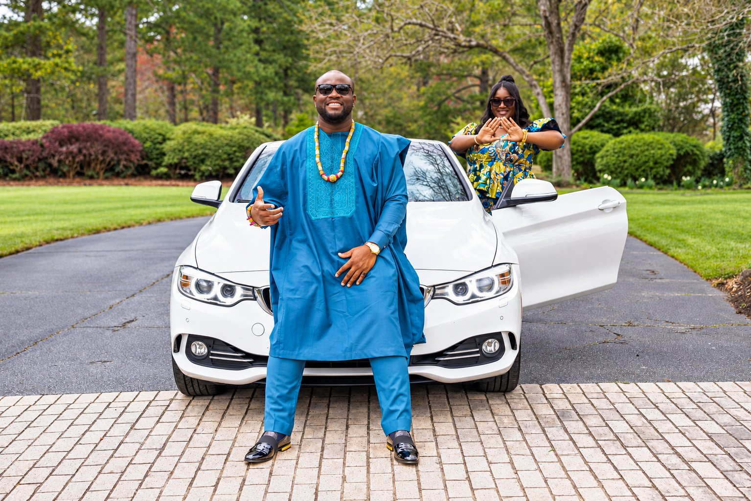 Kobina in blue beside the convertible