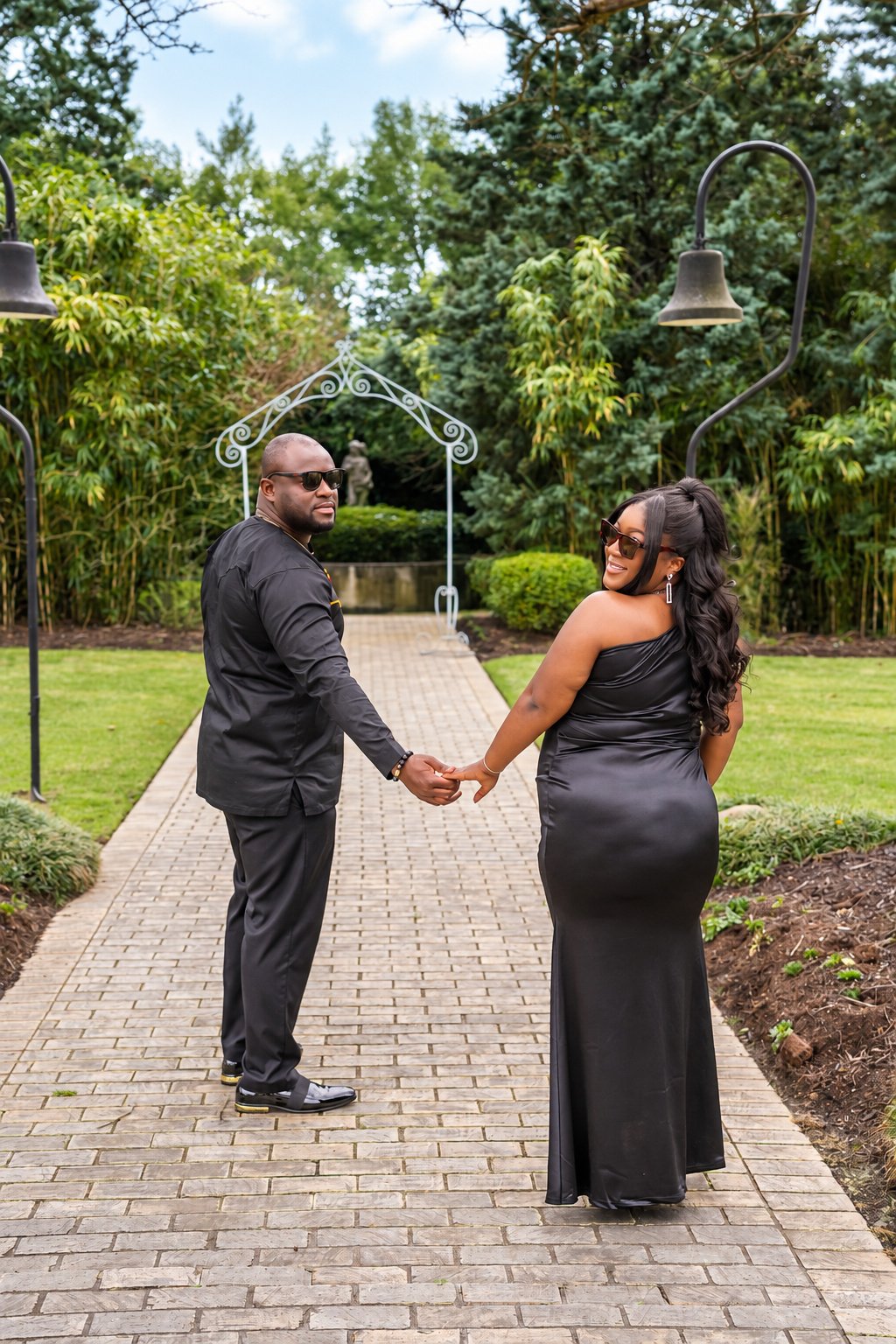 Couple walking hand in hand along the garden path