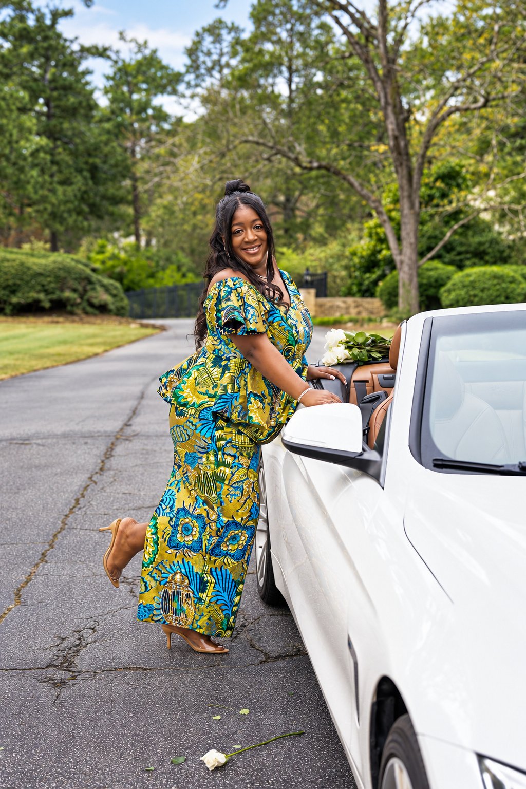 Tiara posing beside the white convertible