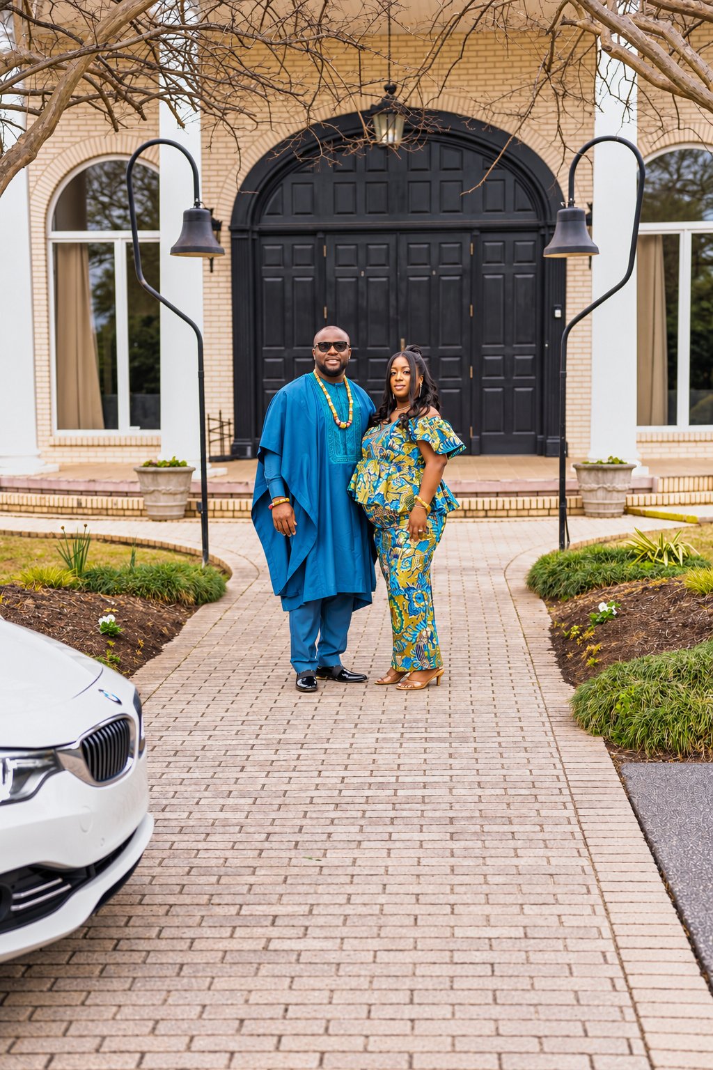 Full-length couple portrait outside the arched entrance