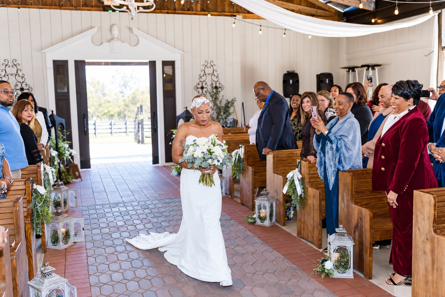 Jillian entering the ceremony as guests look on