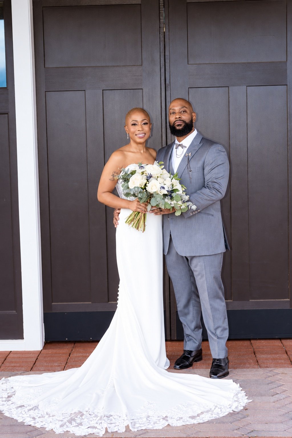 Maurice and Jillian standing together outside the ceremony building