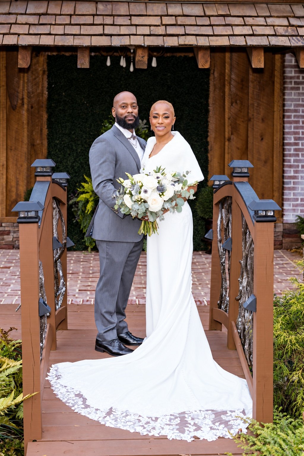 Maurice and Jillian’s portrait outside the wooden entrance at Fendley Farmstead