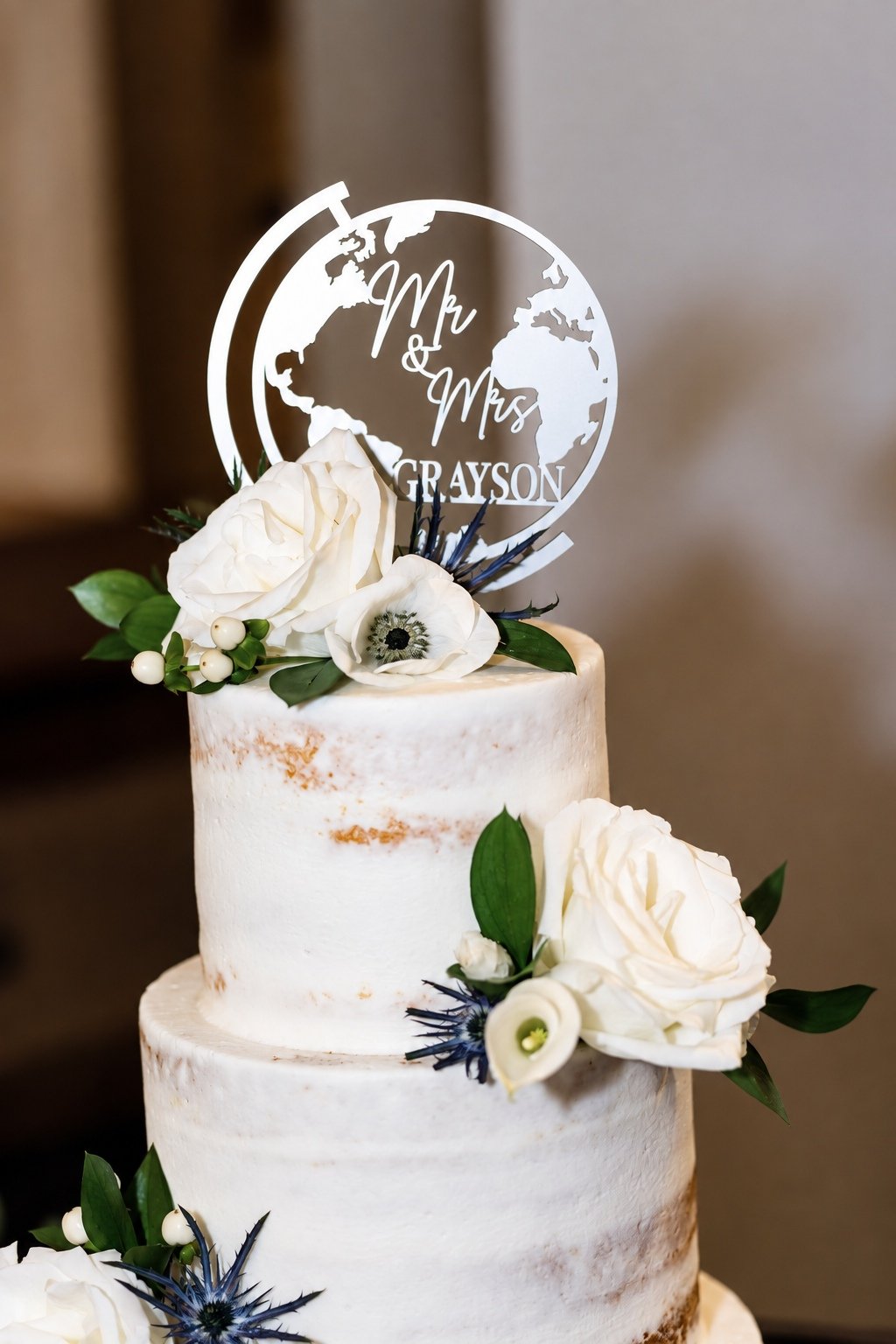 Close view of the floral wedding cake and topper