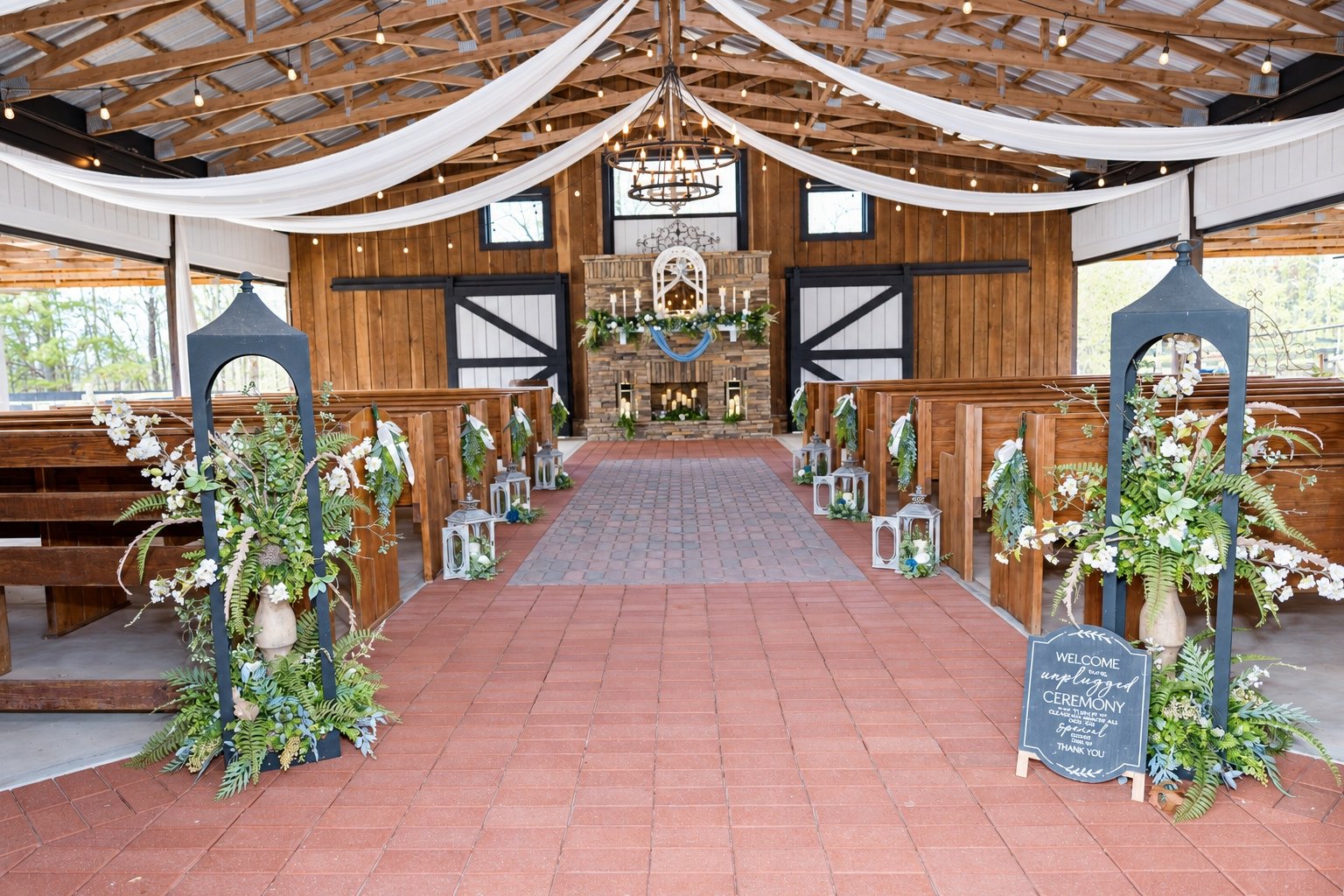 Blue and white flowers lining the ceremony aisle at Fendley Farmstead