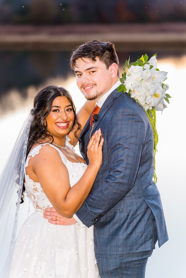 Reeham and Logan embrace during their lakeside portraits