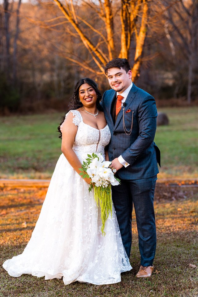 Reeham and Logan pose together with her bouquet