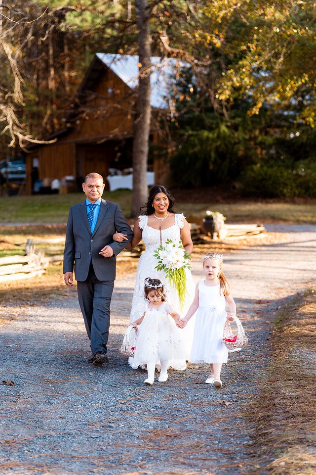 Reeham approaches the ceremony with her escort and young attendants