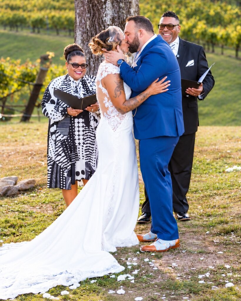 Bride and groom kissing at the ceremony at Montaluce Winery in Dahlonega, Georgia.